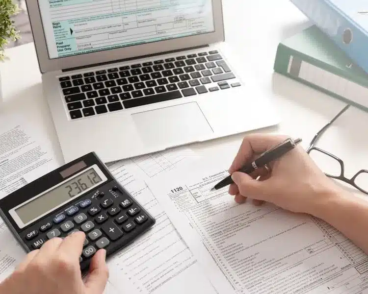 Accountant reviewing figures with a calculator