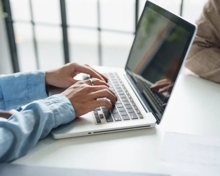 Accountant typing on a laptop at a desk