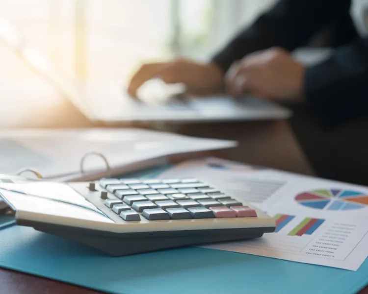 Calculator and financial reports on a desk