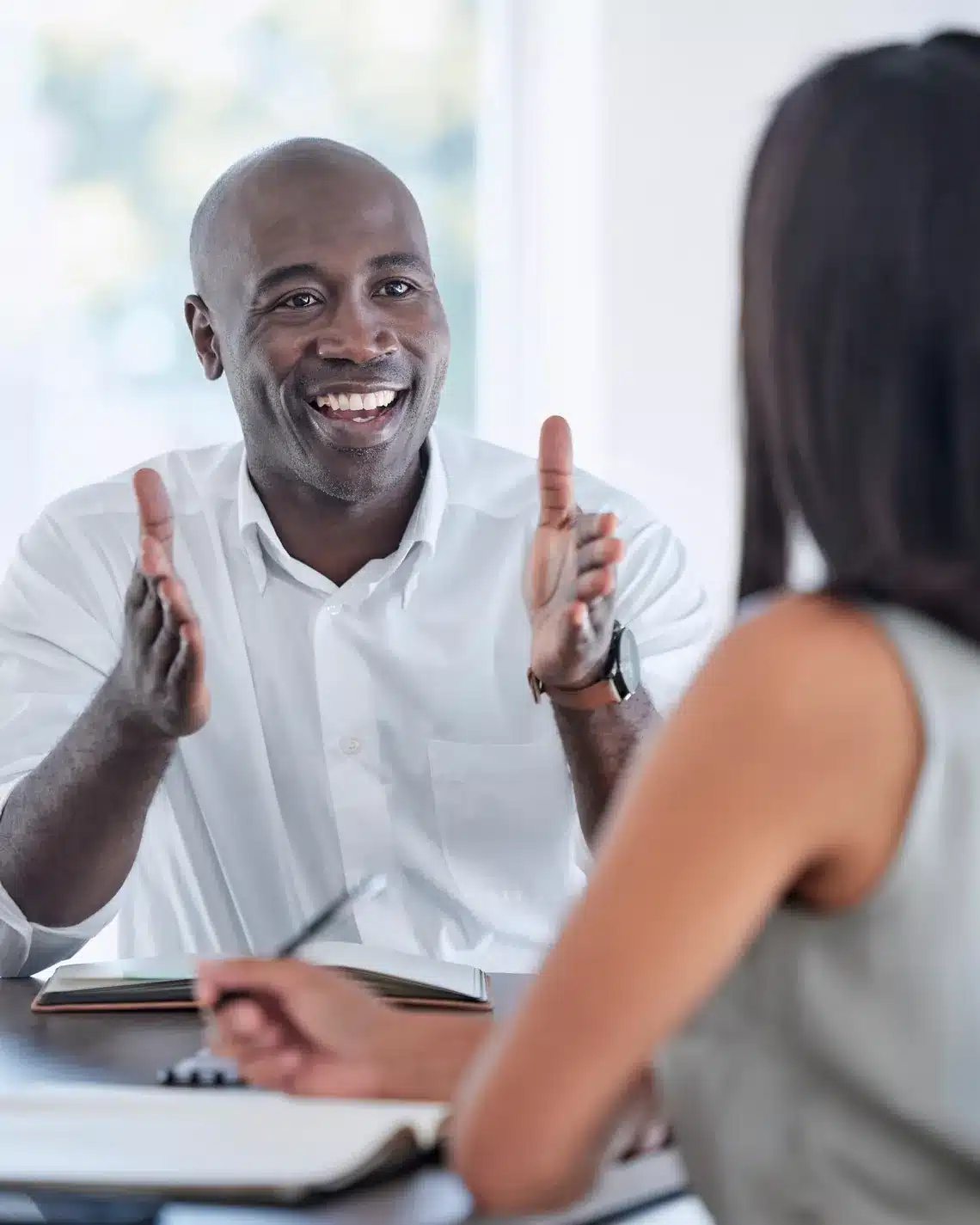Consultant meeting client at office desk