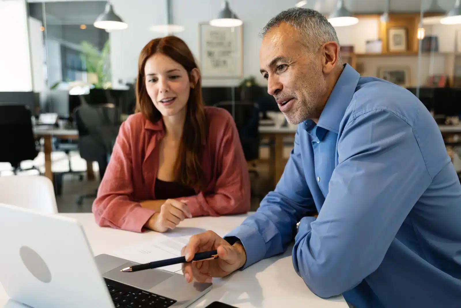 Consultant reviewing proposal with client laptop