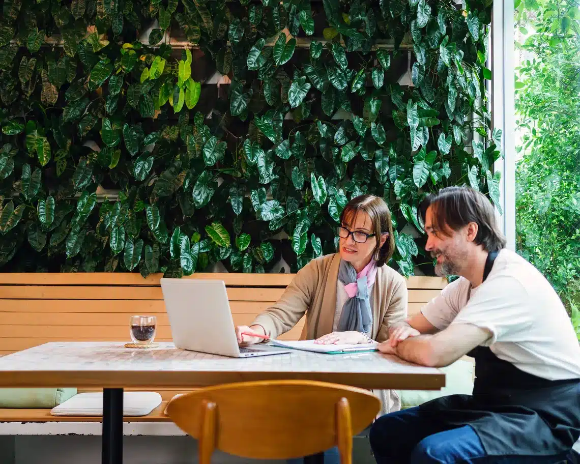 Consultant reviewing results with cafe owner Consultant reviewing results with cafe owner