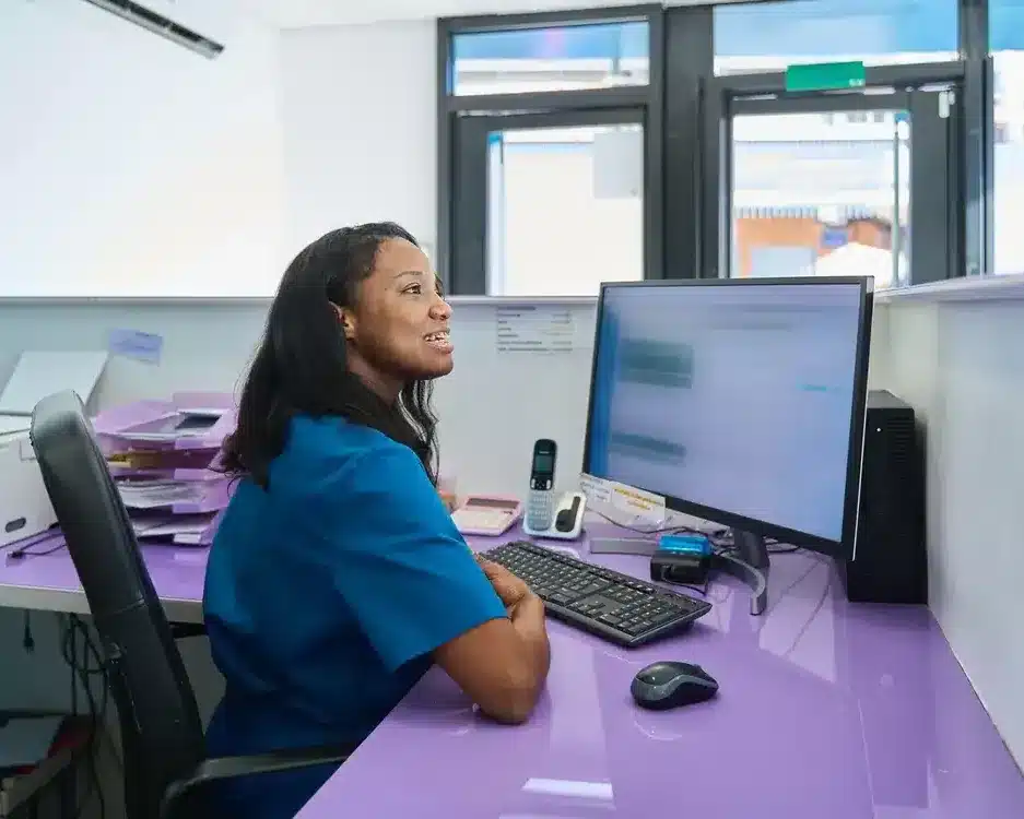 Dental receptionist at the front desk computer