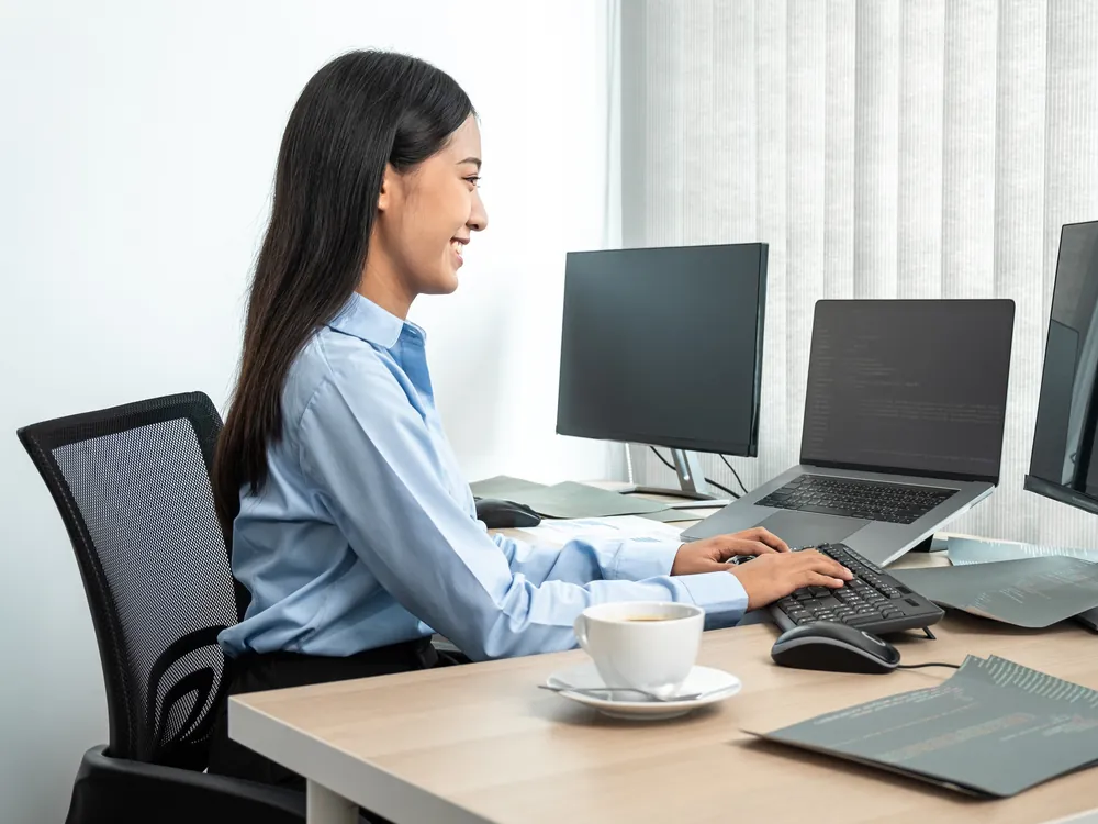 Web professional working at multiple monitors during a technical SEO and GEO audit