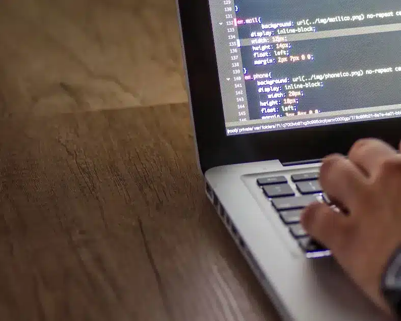 Developer writing code on a laptop Developer writing code on a laptop