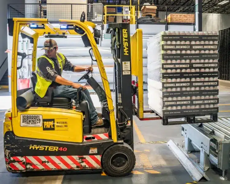 Forklift moving pallets in a warehouse