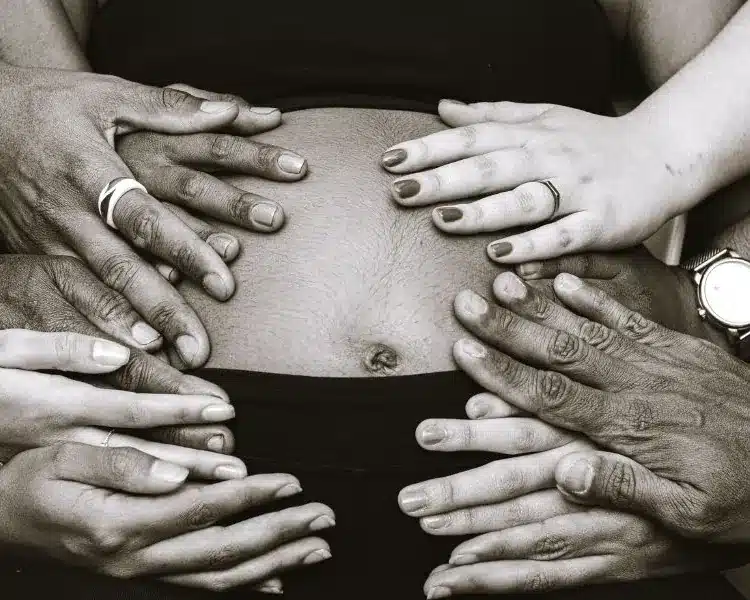 Hands resting on a pregnant belly
