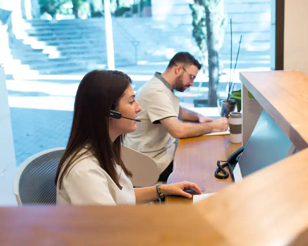 Law firm intake coordinator with a headset at the front desk