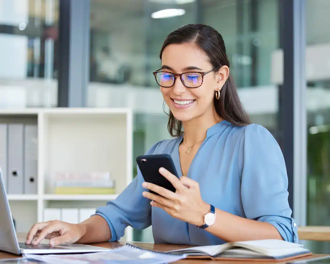 Marketer checking social media phone laptop
