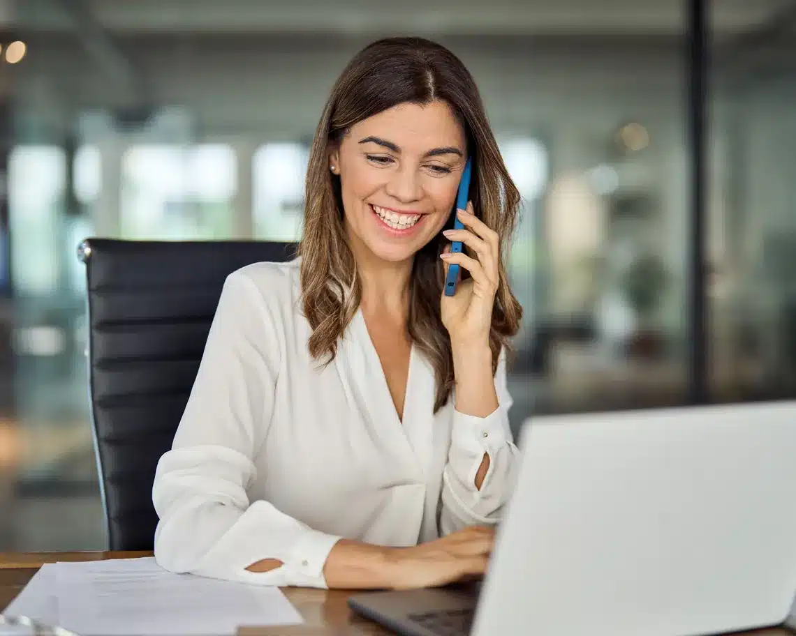 Marketer on phone call with client at desk