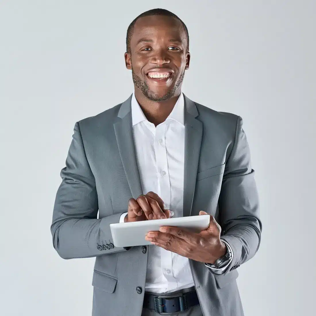Smiling consultant in a gray suit using a tablet