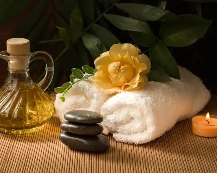 Spa stones, oil and a towel in a wellness setting Spa stones, oil and a towel in a wellness setting