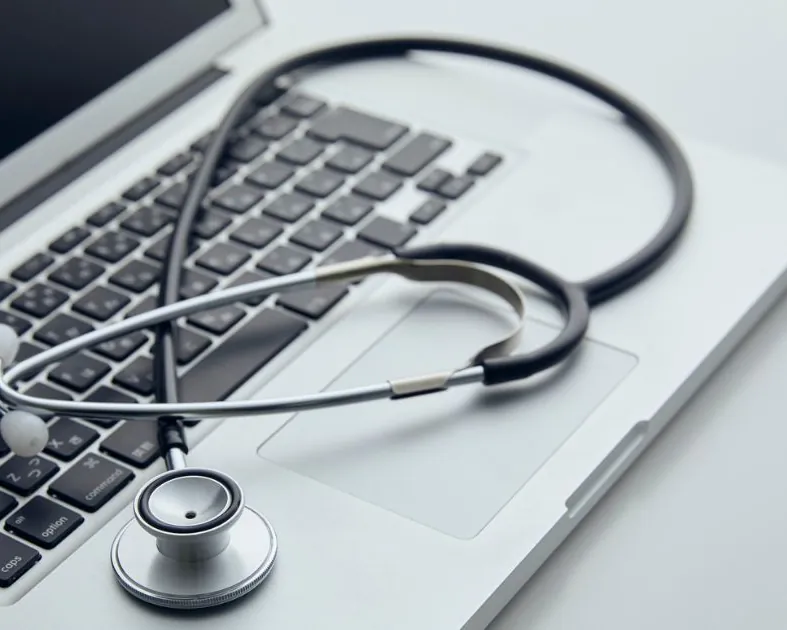 Stethoscope resting on a laptop keyboard Stethoscope resting on a laptop keyboard